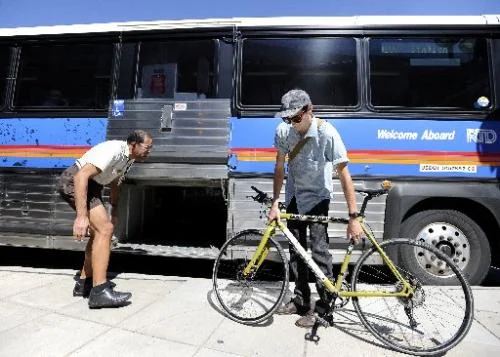 Denver's RTD (transit buses) take people between Denver and Boulder and accept bikes in luggage.