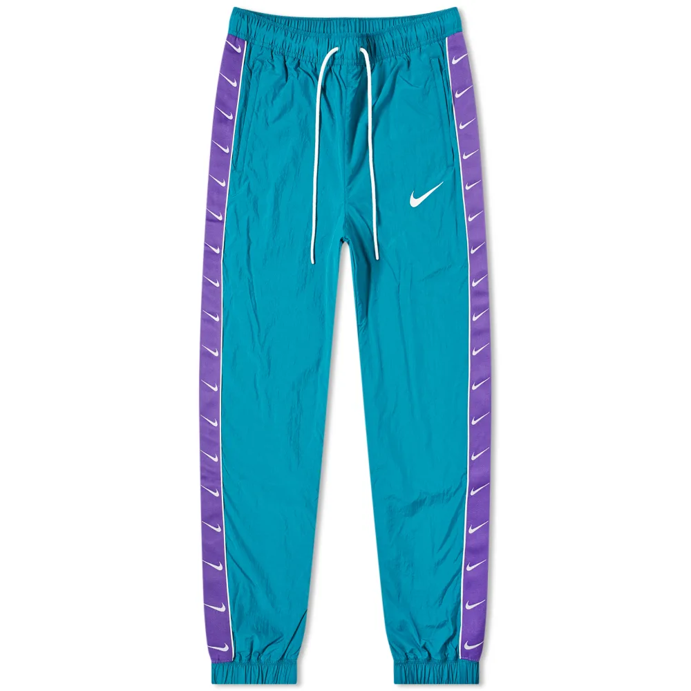 25-06-2019_nike_tapedswooshwovenpant_geodeteal_courtpurple_cd0421-381_th_1.png
