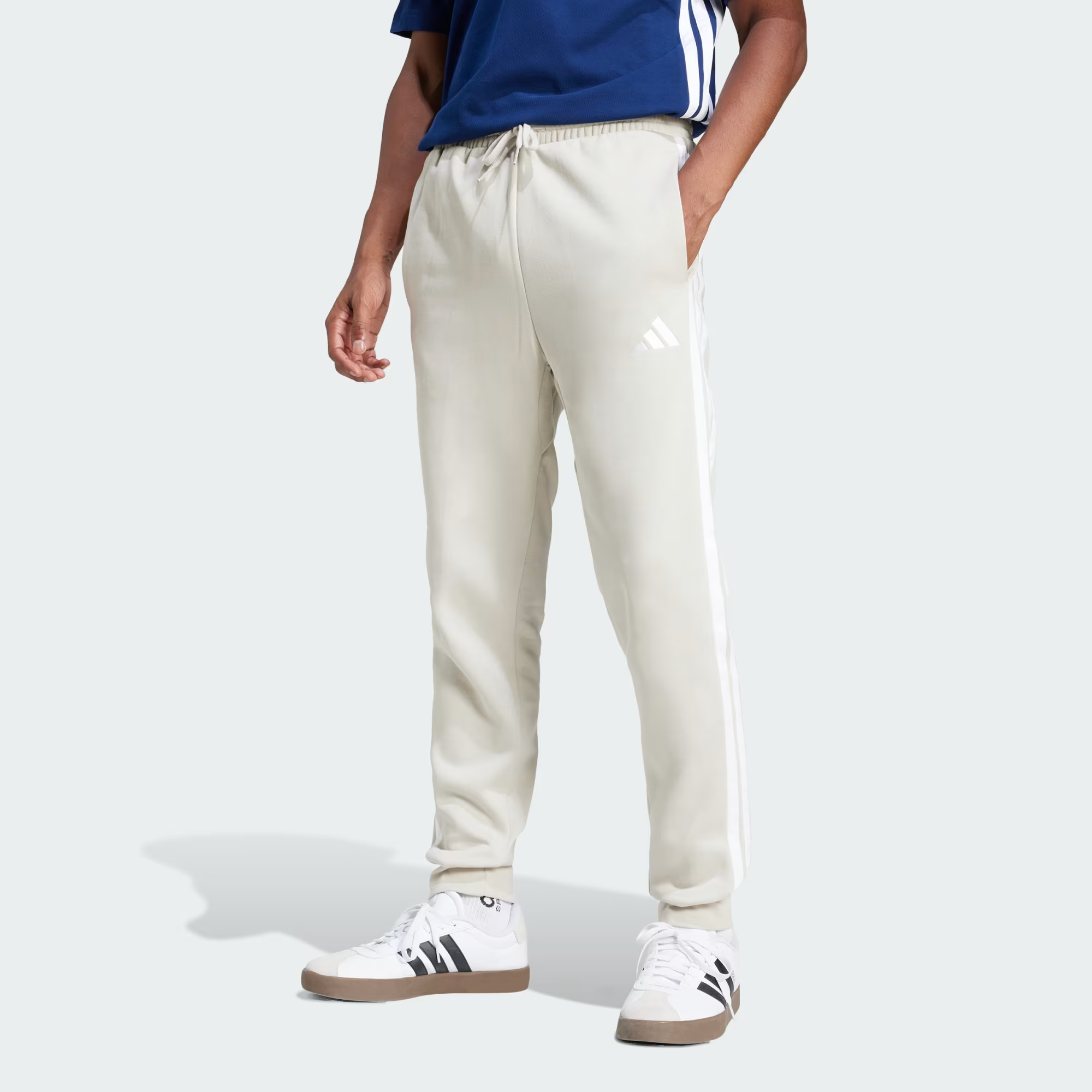 Essentials_3-Stripes_Fleece_Pants_Beige_JE6317_21_model.png