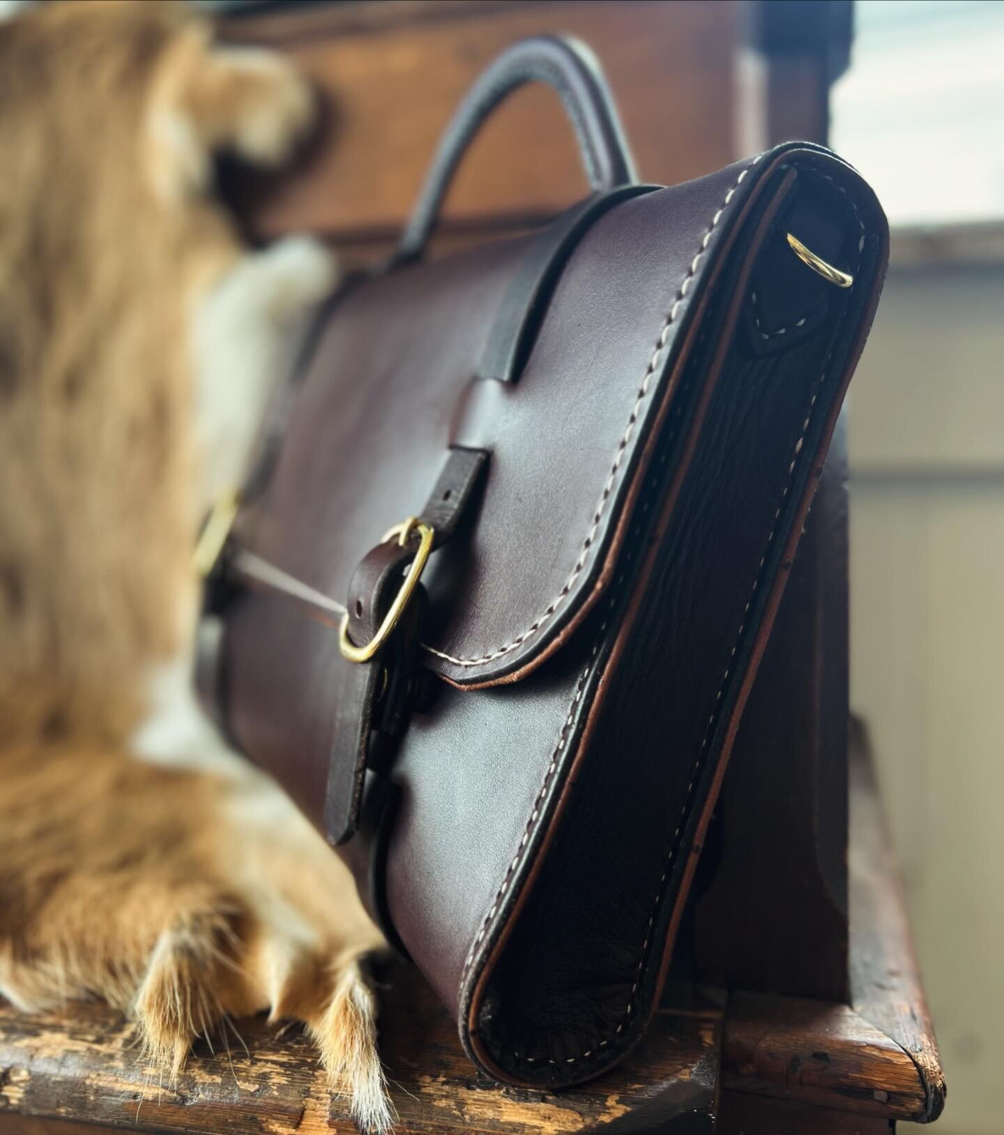 The perfect work bag. Elegant, simple and built to last for generations. Hand-stitched dark brown English bridle leather with an exquisite embossed ostrich lining. This is one of Victor Powells original designs that I made come to life from an old ph