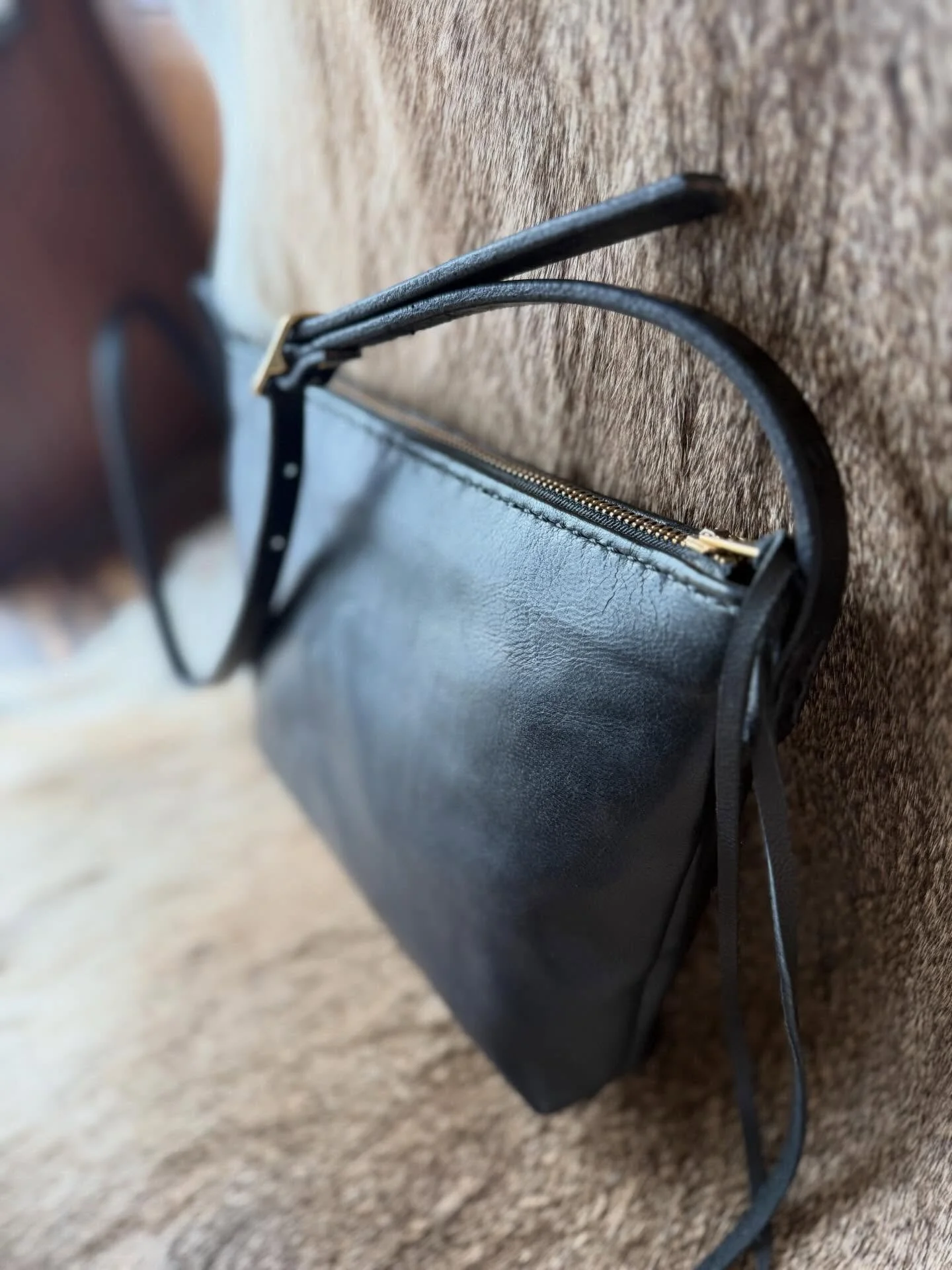 The Boat Bag. 
Extremely lightweight. 
Oiled lamb suede. 
Zipper closure.
Crossbody adjustable strap. 
Prefect size. 
Wears in beautifully.
I am so happy to have these bbs back in stock! Stop in today and tomorrow for 10% off all bags and wallets for