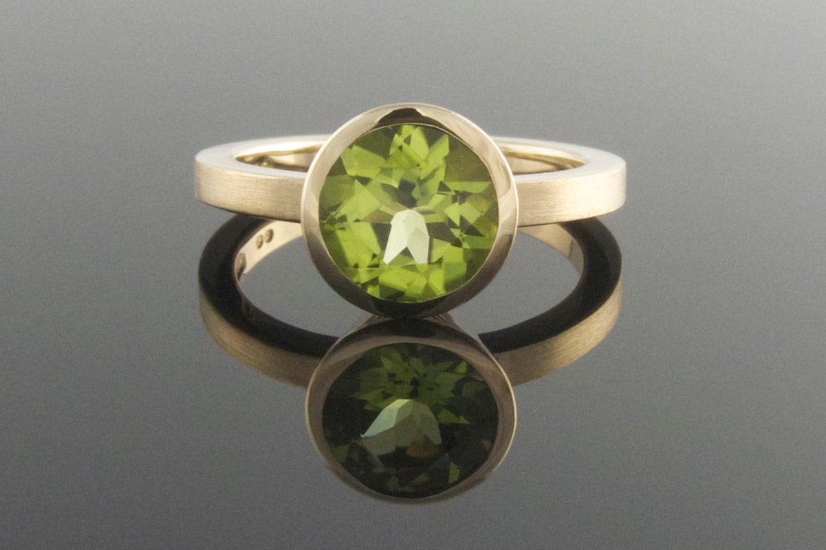 Bezel set peridot engagement ring