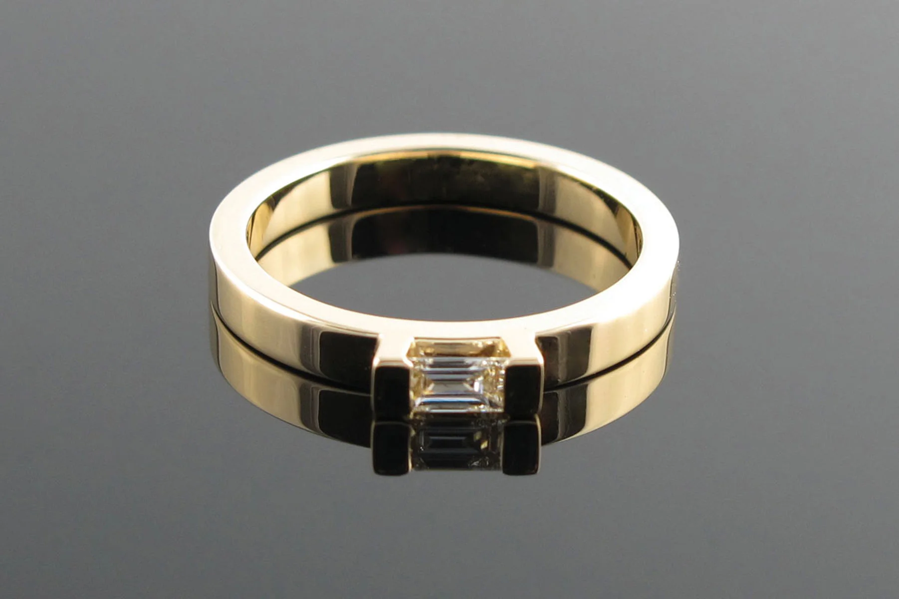 Emerald cut diamond engagement ring in yellow gold