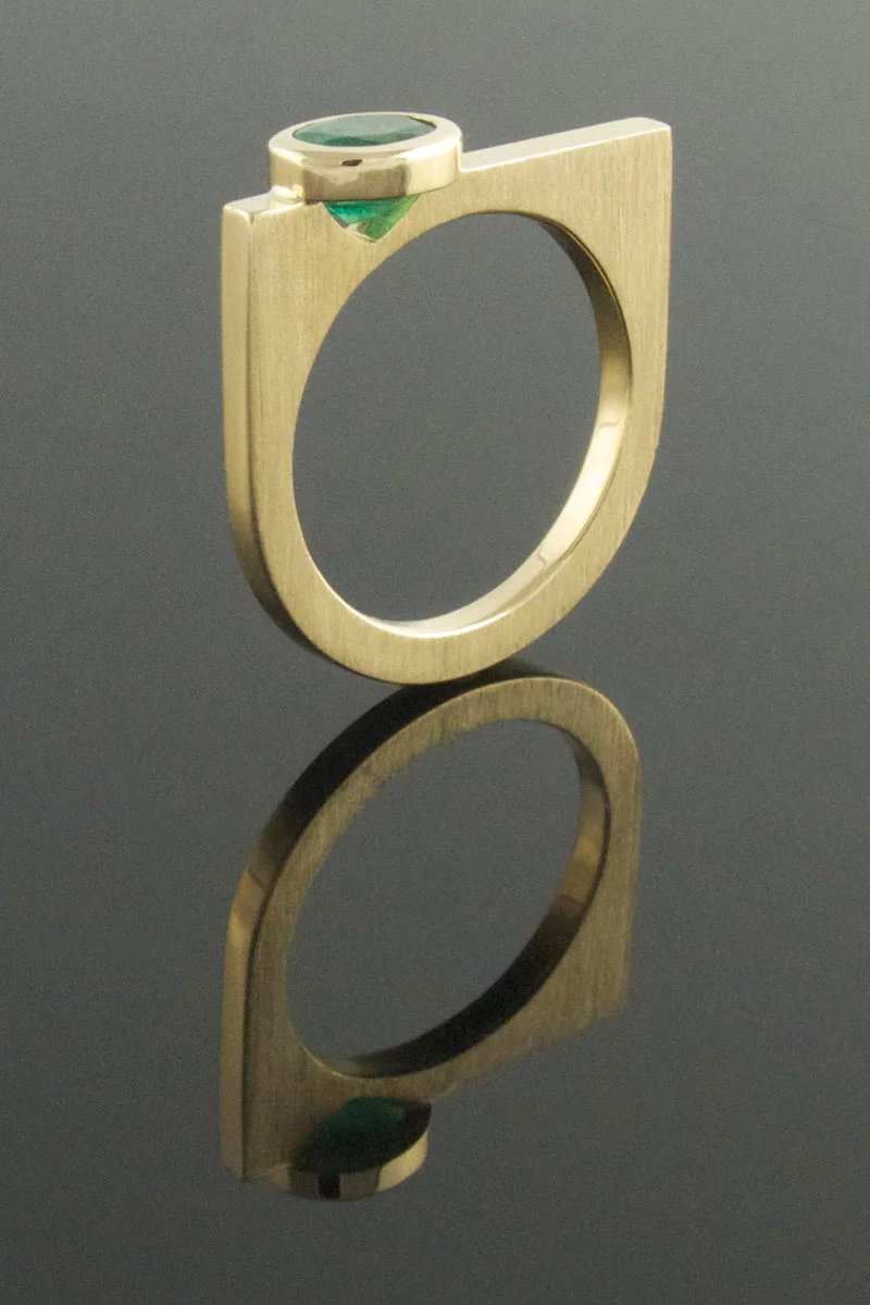 Bezel set oval emerald U-shaped ring