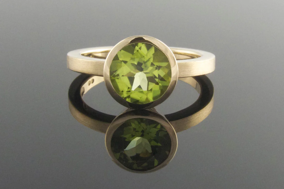 Bezel set peridot engagement ring