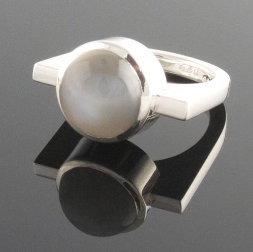 Contemporary grey moonstone cabochon bezel set in sterling silver on a U shaped dress ring