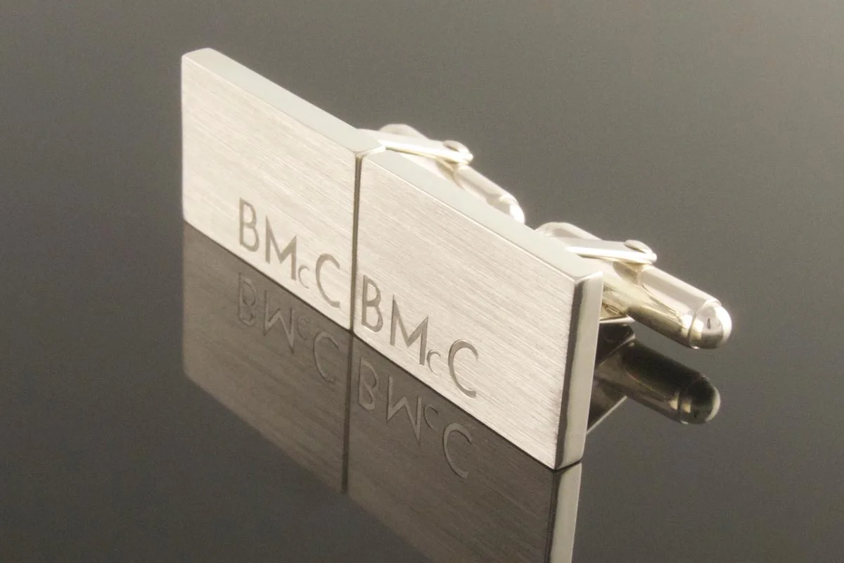 Rectangular silver cufflinks with engraved initials