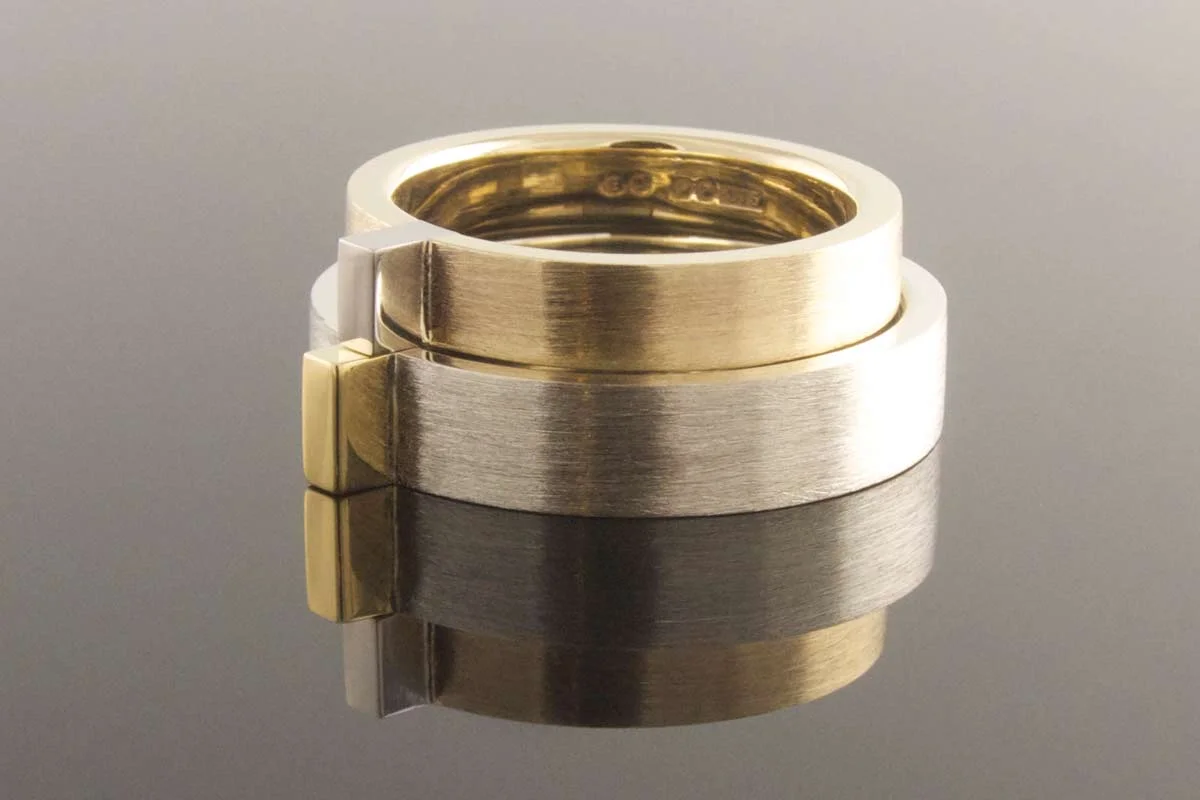Gold and platinum wedding bands with raised detail