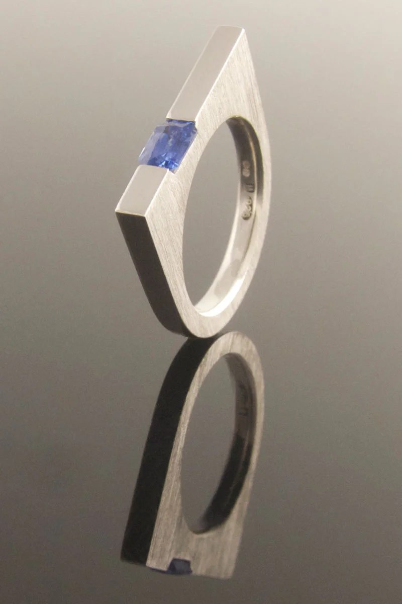 Contemporary emerald cut blue sapphire U-shaped silver ring