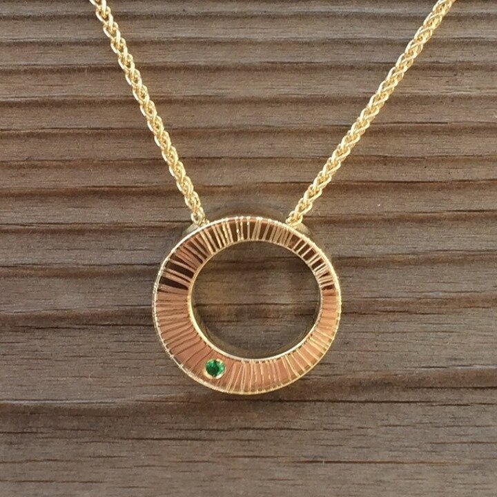 Another emerald for the month that's in it! This round gold pendant has room for a little stone which is just what Joey ordered to mark the imminent birth of his baby daughter. Such a thoughtful gift.... &ldquo;she was thrilled with it, loved having 