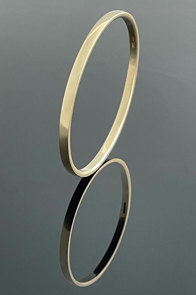 Oval half round profile solid 9ct yellow gold bangle measuring 4mm wide by 2.5mm deep, matte finished