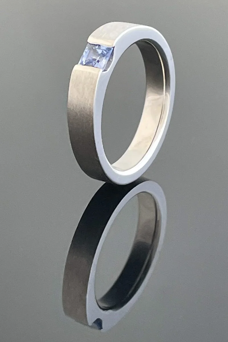 Princess cut pale blue sapphire solitaire engagement ring in platinum