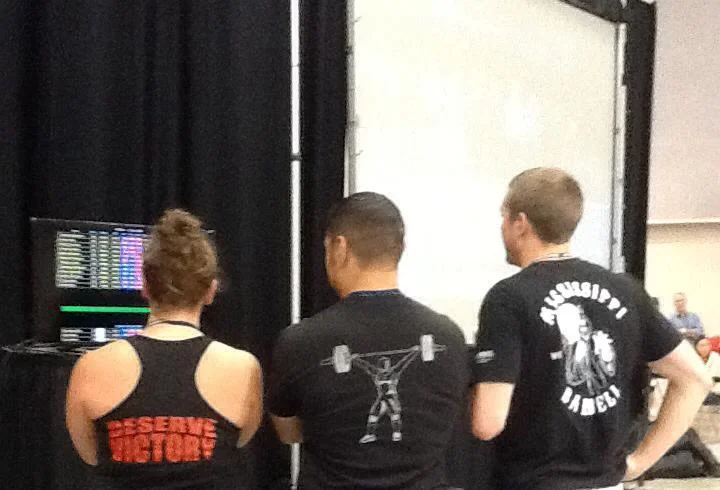 Coach Sheppard (far left) and Coach Smith (right) learning from Camargo (center) at a national event in 2014. Photo credit: Vic Sanders