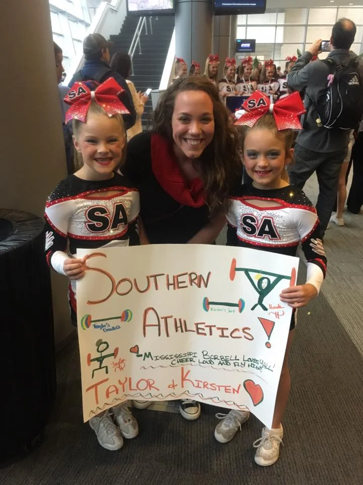 9 year old youth athletes TG and KD with Coach Amber after their local cheerleading competition.
