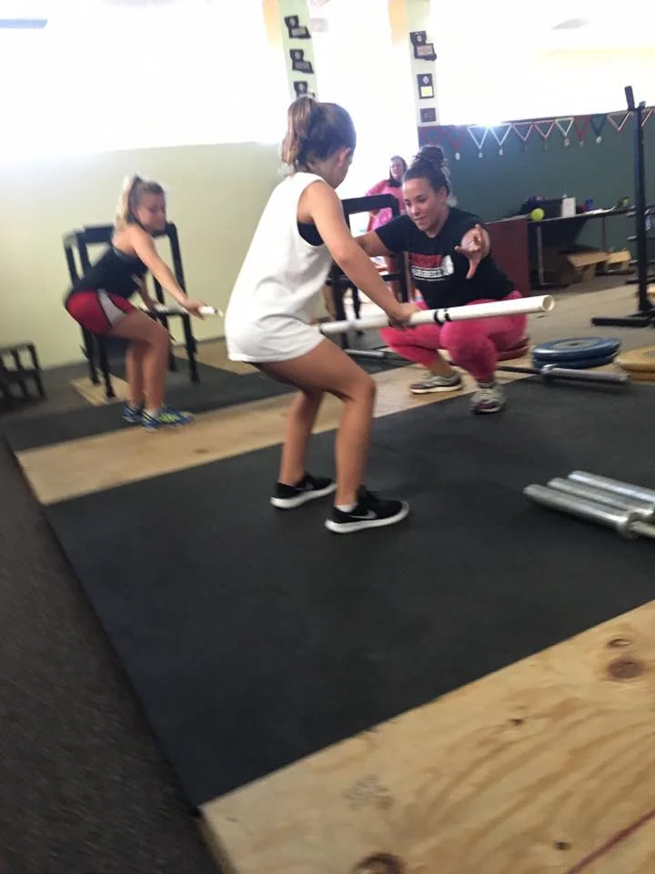 Youth, aged 8-10, earning with a PVC pipe on their first day with Coach Sheppard.
