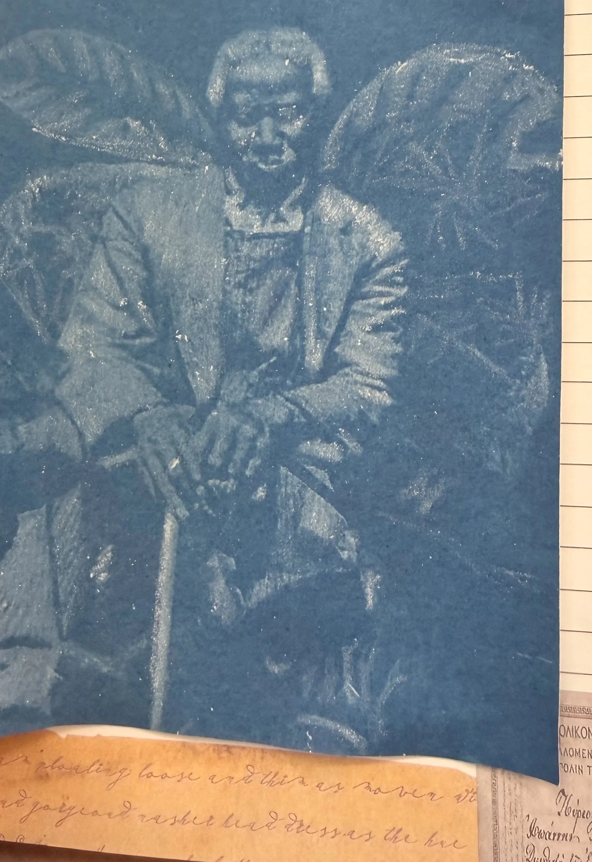 A chalk drawing of a woman with angel wings on a blue background.
