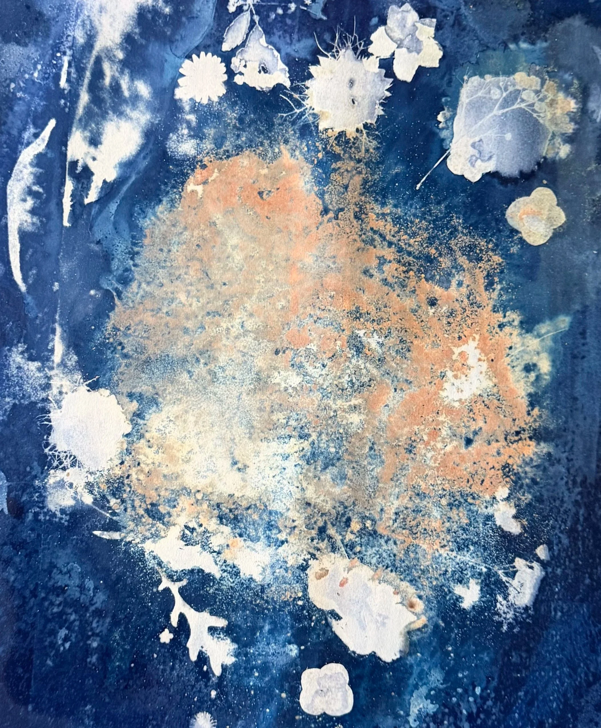 A blue background with various white and light-colored plant, leaf, and floral-shaped patterns, some resembling paint splatters or stencils.