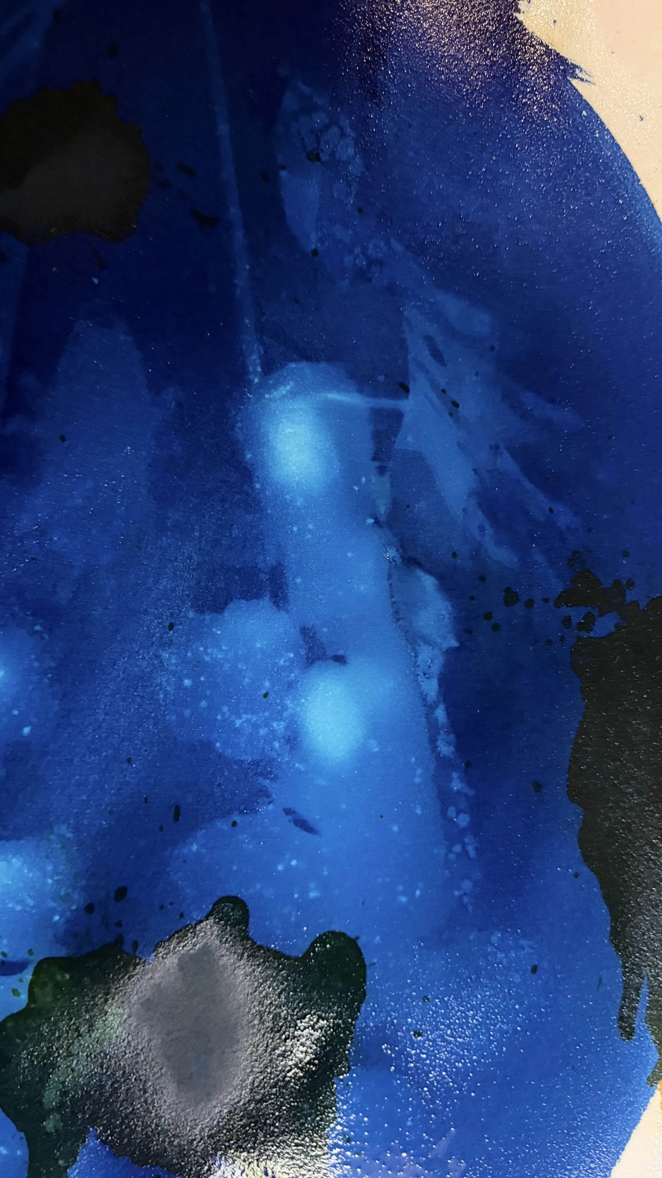 Abstract blue, black, and white splatter painting with textured and layered appearance.