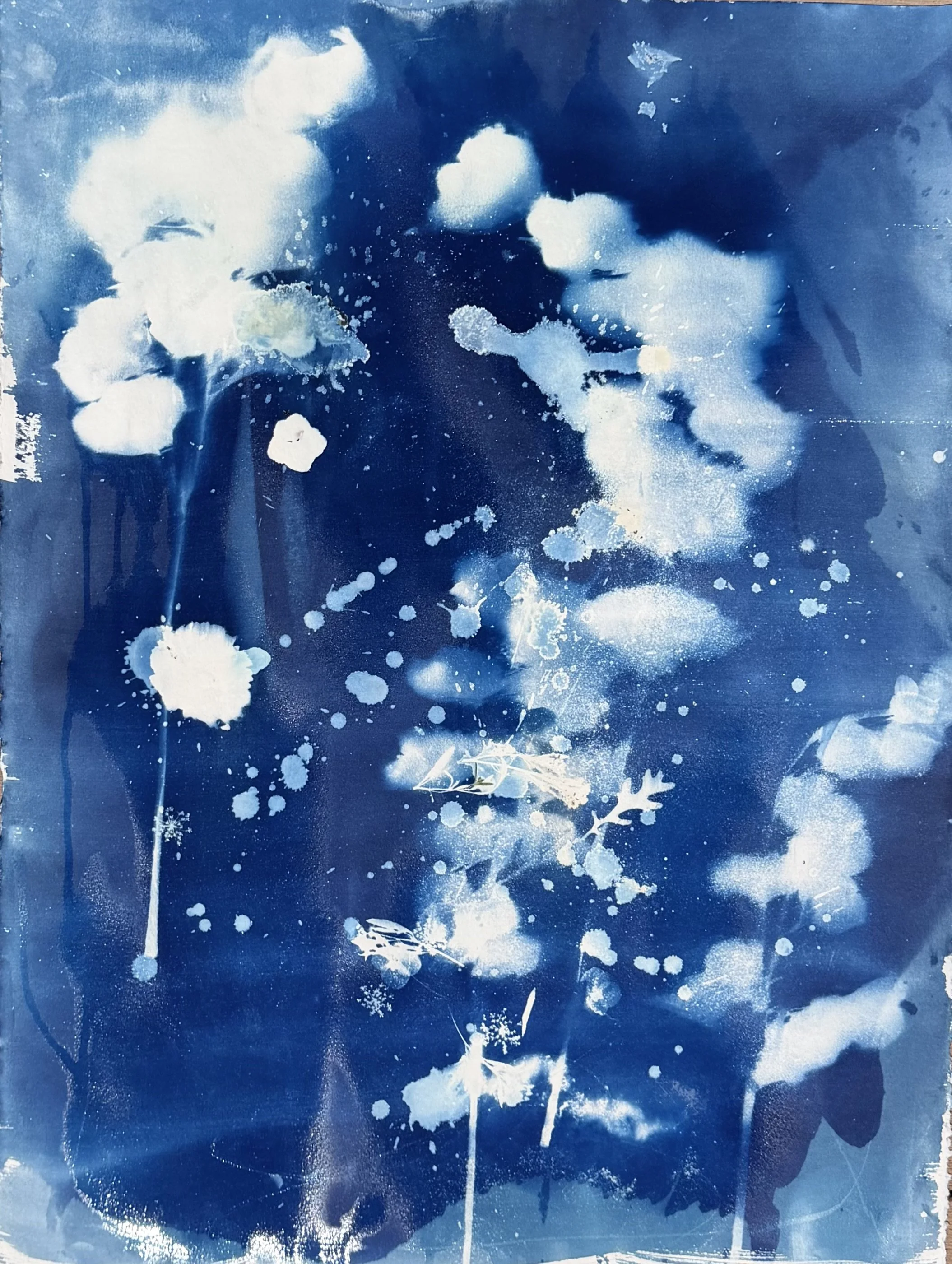 Blue abstract background with white paint splatters and drips.