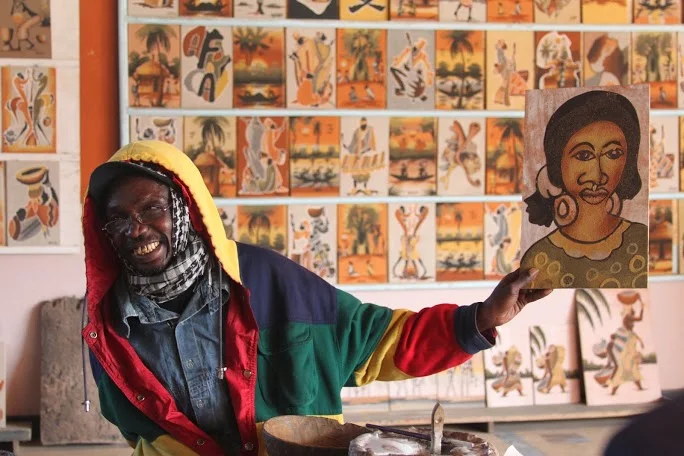  Sand artist showing a completed painting. | Dakar, Senegal&nbsp; 