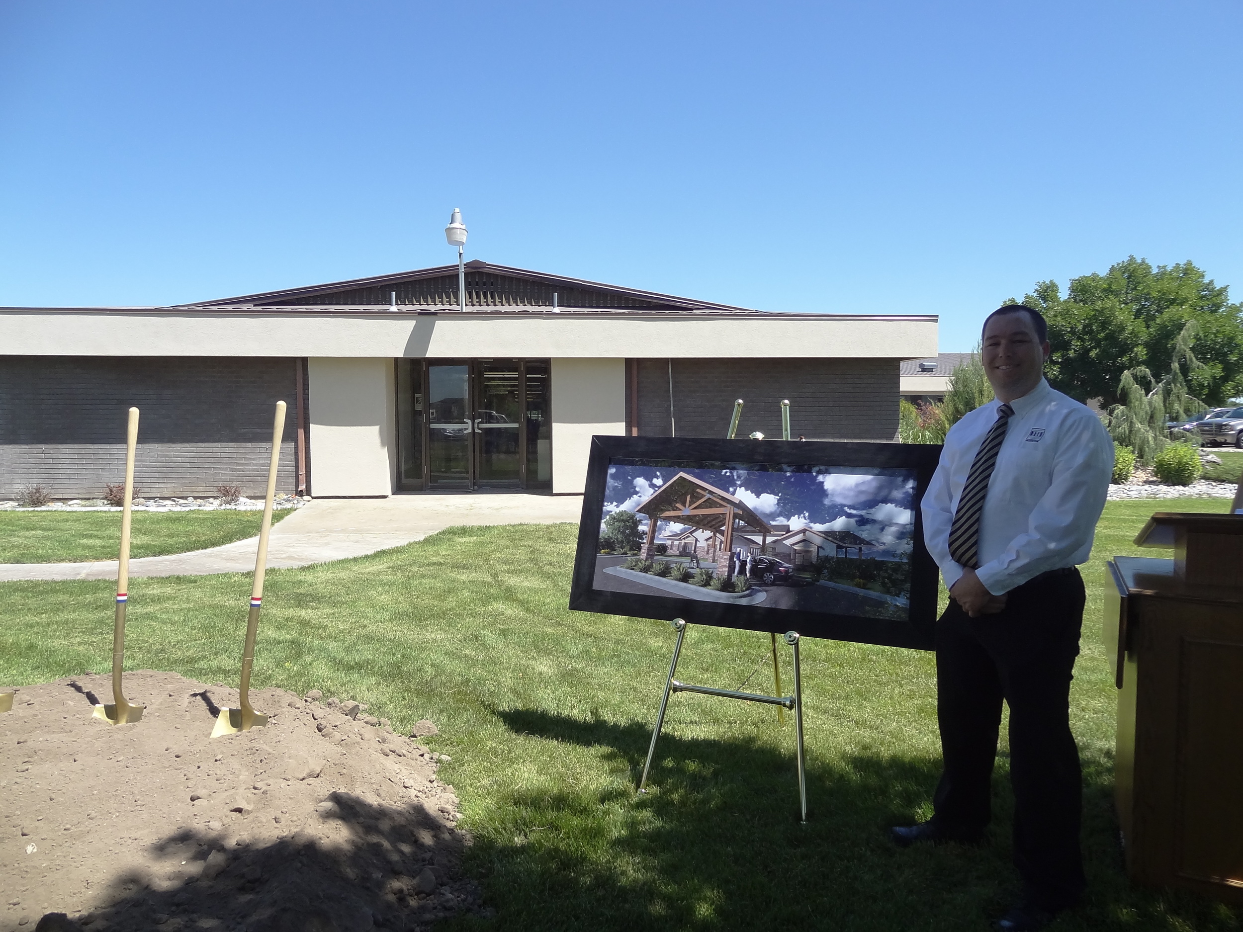 DEIV Architecture's President, David Clayton, AIA, standing in front of the rendering of how the facility will look upon completion. 
