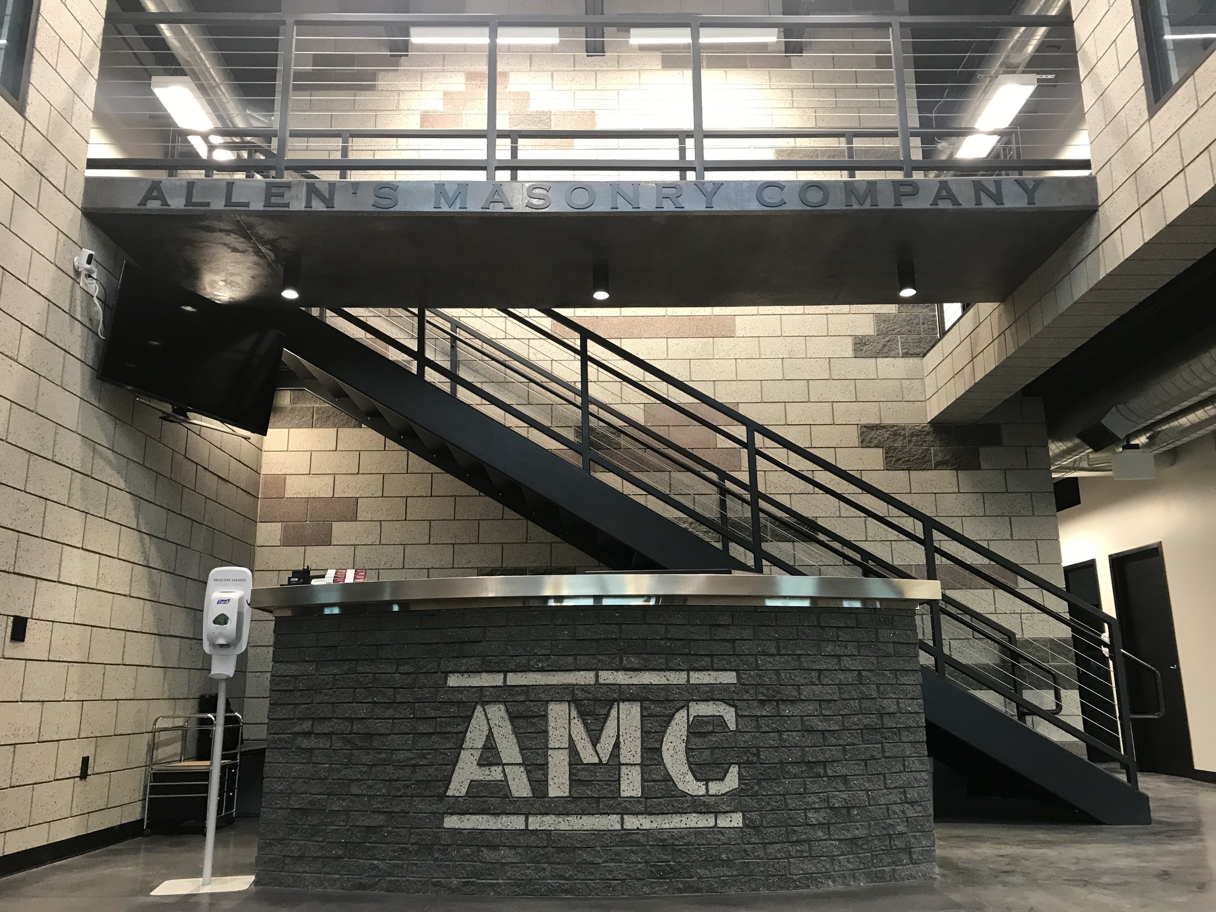 The entry lobby features beautiful lighting and an exciting stair and bridge on the upper level.