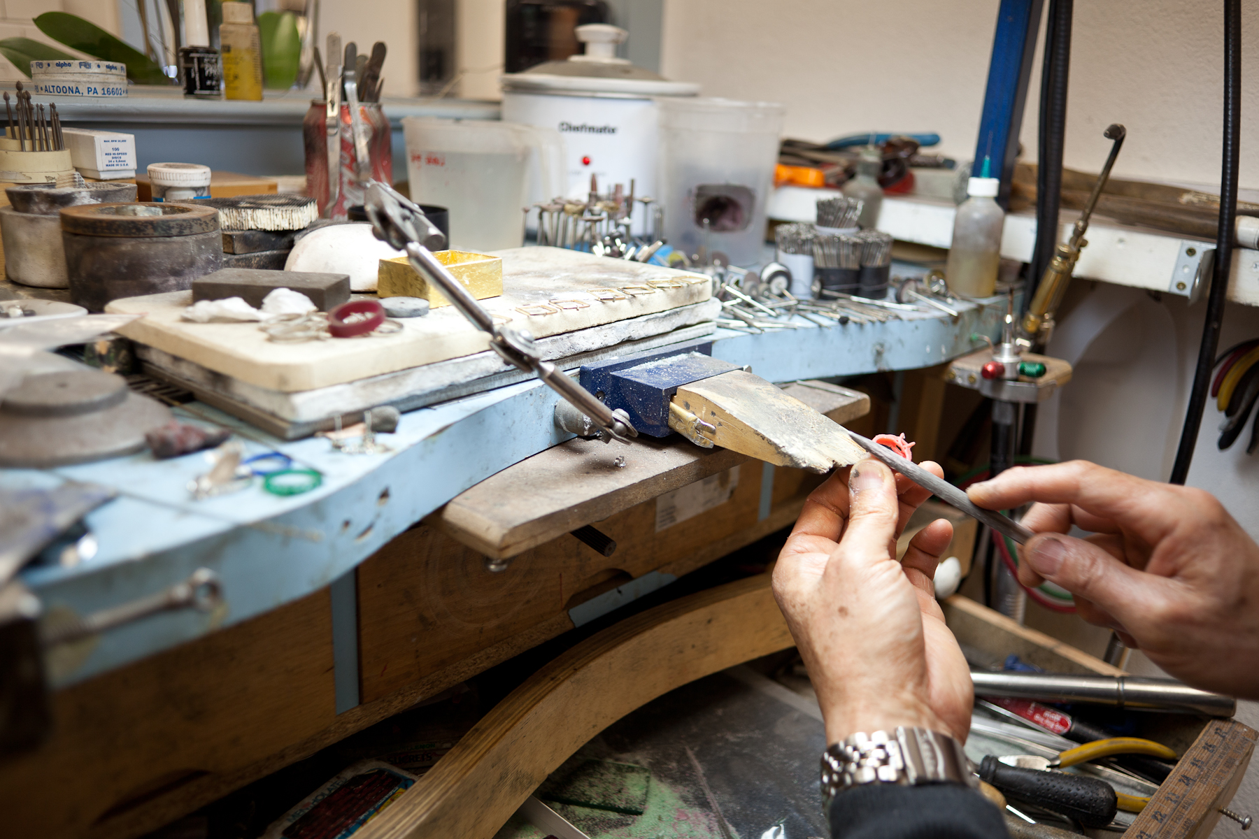 I love the mix of tools - files, torches, wood blocks, a crock pot.