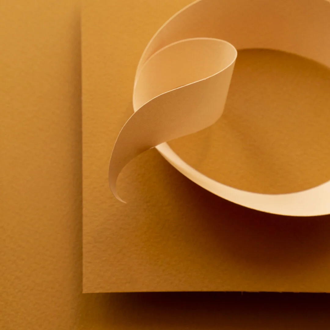 Close up of curled end of a paper letter Q