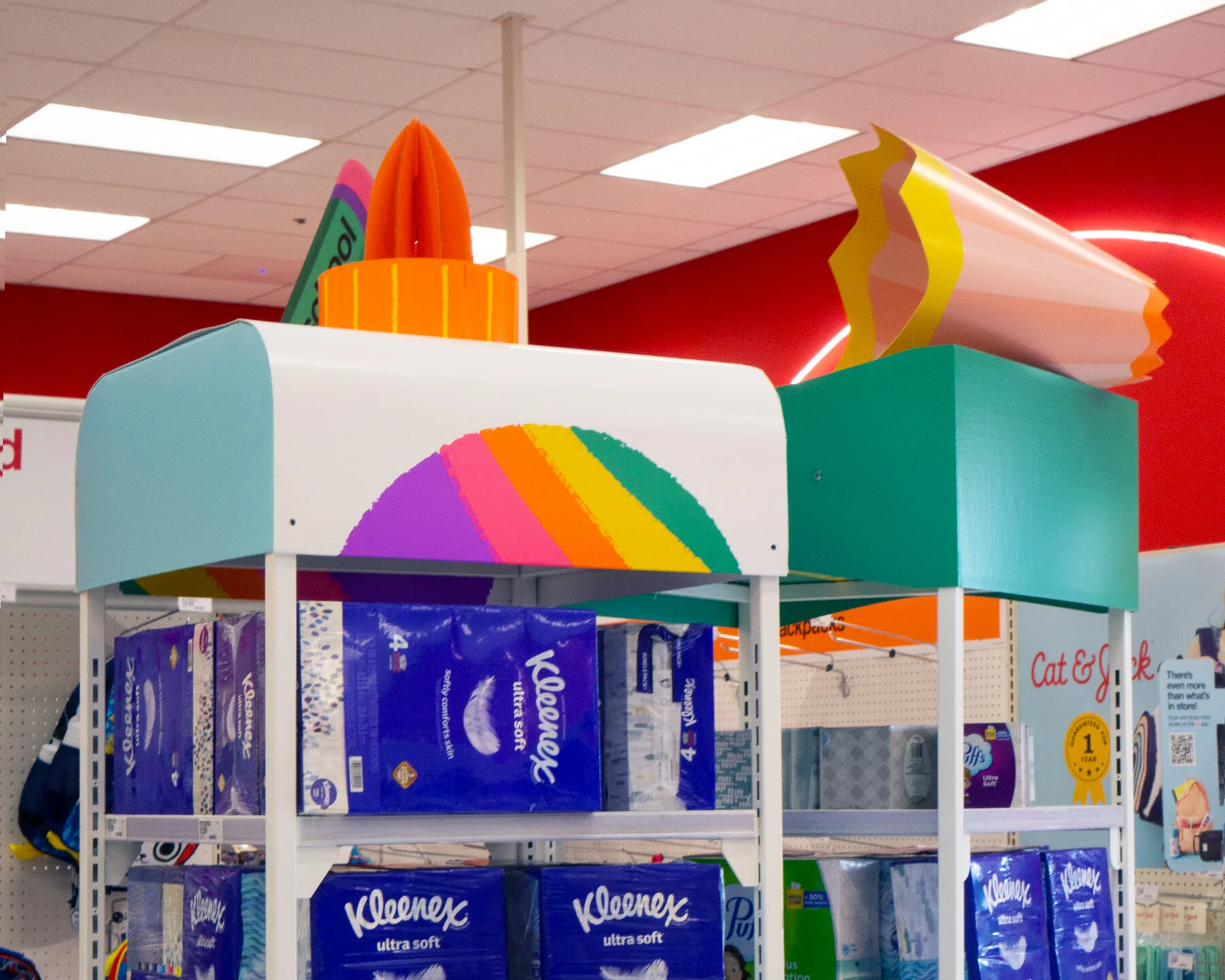 Photo taken inside a Target store with a large paper glue bottle top sitting on a shelf of products
