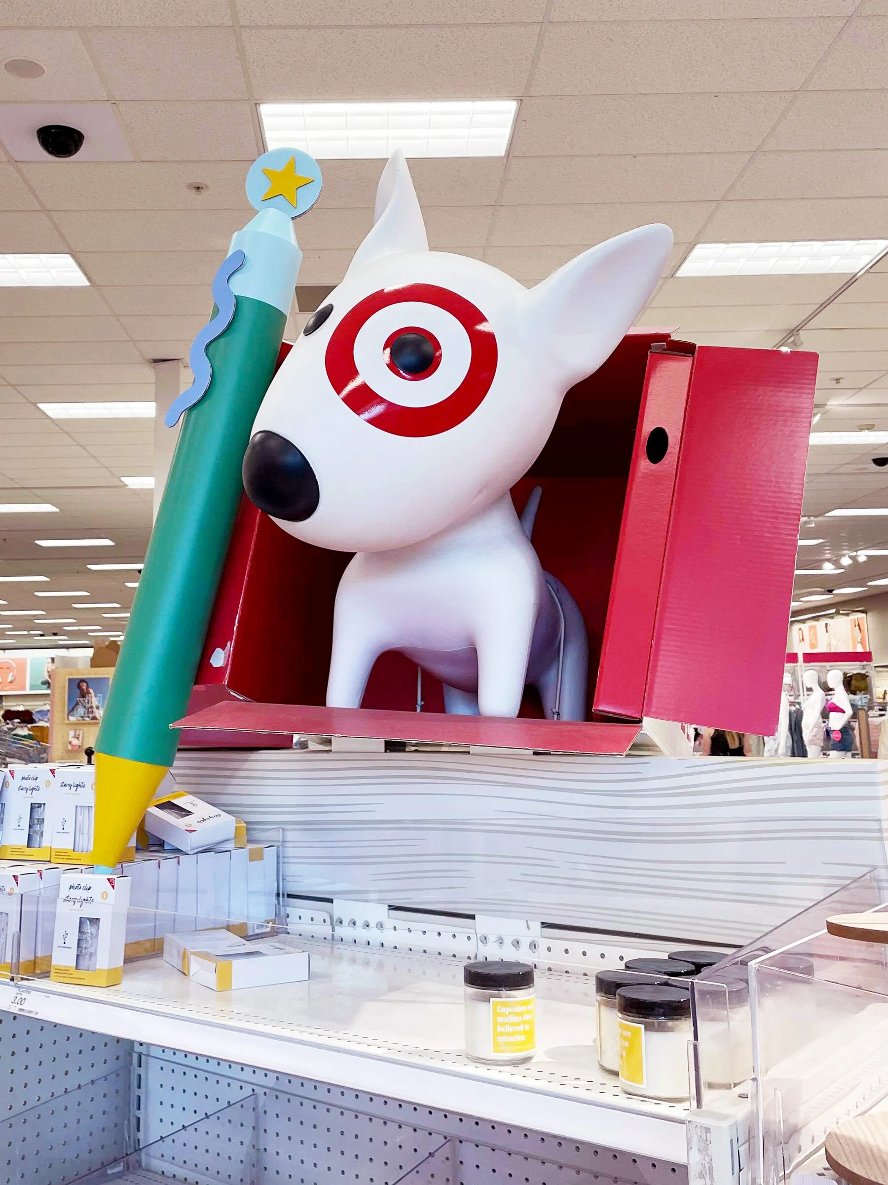 Photo of large paper pen next to a statue of Target's mascot dog