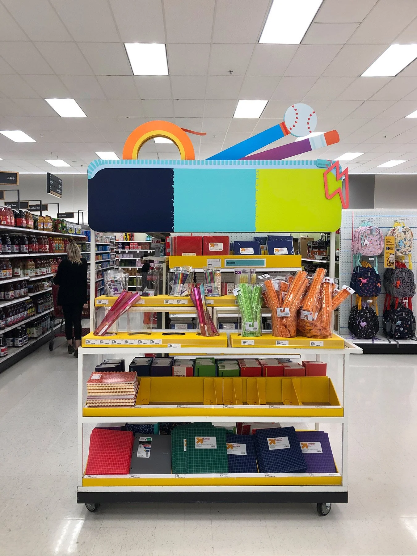 Photo of a product shelf at Target, topped with a giant paper pencil case