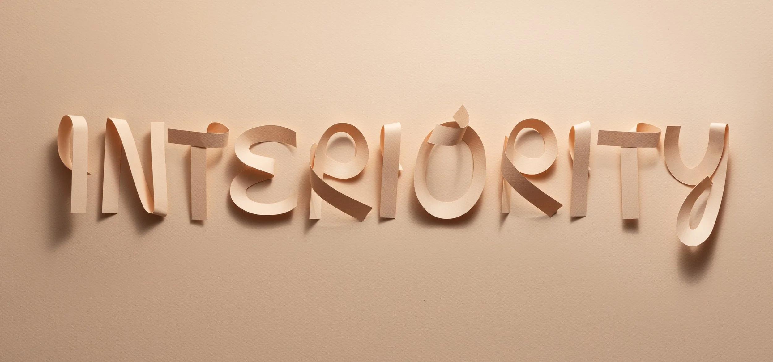 Paper letters spell out the word "interiority"