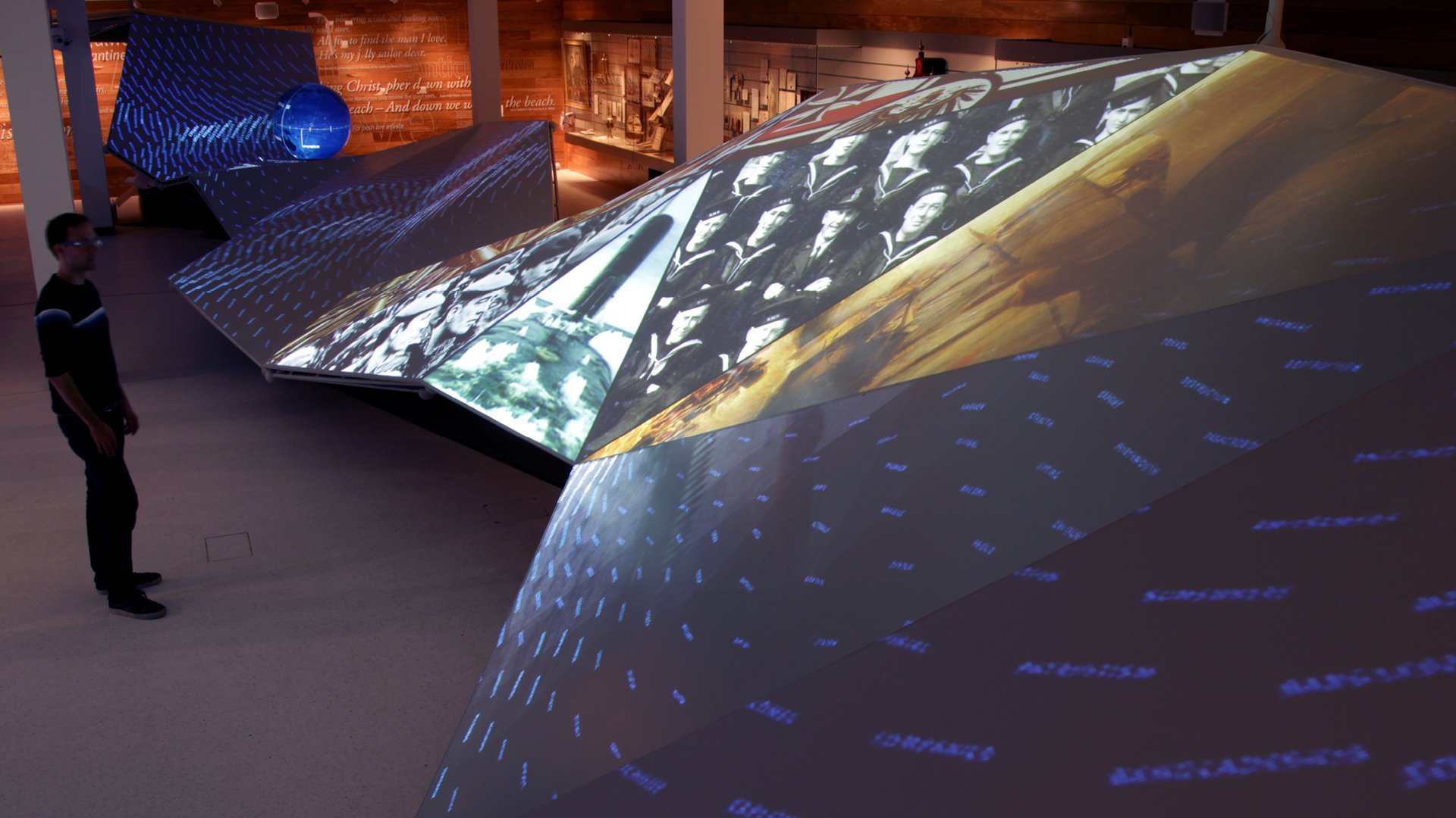 The gallery was dominated by a 20-metre projection-mapped wave that stretched the room’s full length. The wave was made up of 26 triangular facets and featured a spherical projector at one end.