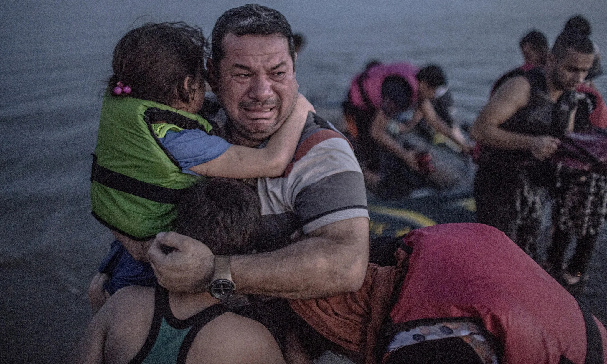 Main photograph by Daniet Etter/New York Times/Redux /eyevine. Laith Majid cries tears of joy and relief that he and his children have made it to Europe.