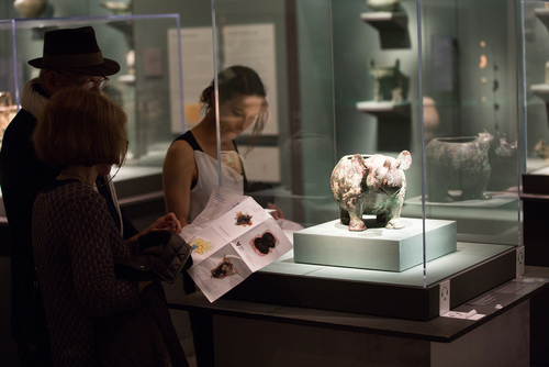 Visitors examine 11th century Chinese bronze vessel in the shape of a rhino, described by Jay Xu.