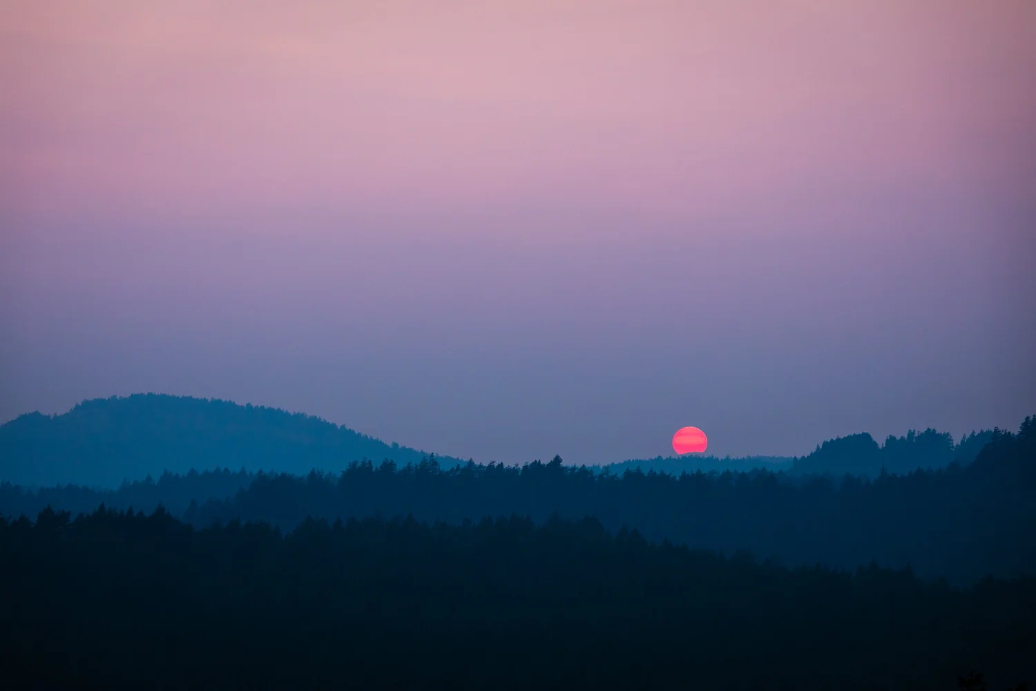 Smoke from the wildfires that raged through BC's interior made its way over to Vancouver Island as well this summer. Seen here is the view of sunset from one of my favourite lookouts in Metchosin, Mt Helmcken, at the top of Neild Rd. The pastel haze created a painterly (albeit ominous) feel across the sky and the rolling landscape of the Sooke Hills.