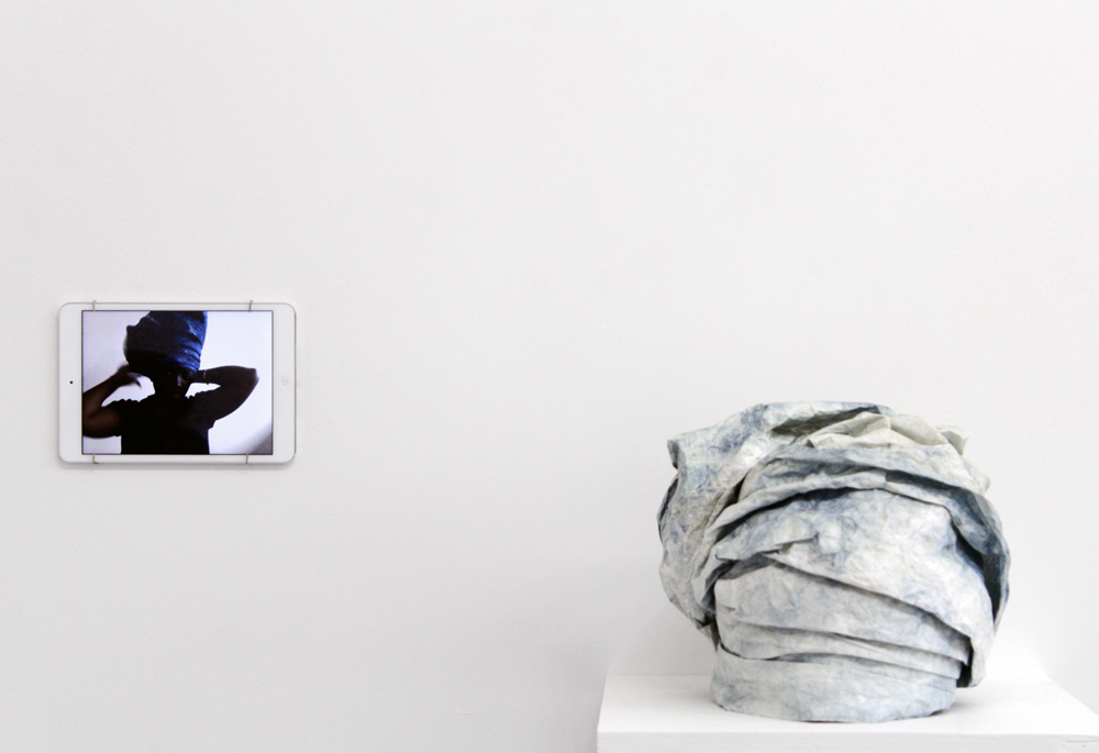 Bukola Koiki from the series I Claim That Which Was Never Mine, Tyvek Gele 1 , 2014, Tyvek, natural indigo, and thread, 10.5 x 9.75 x 9” & MP4 video