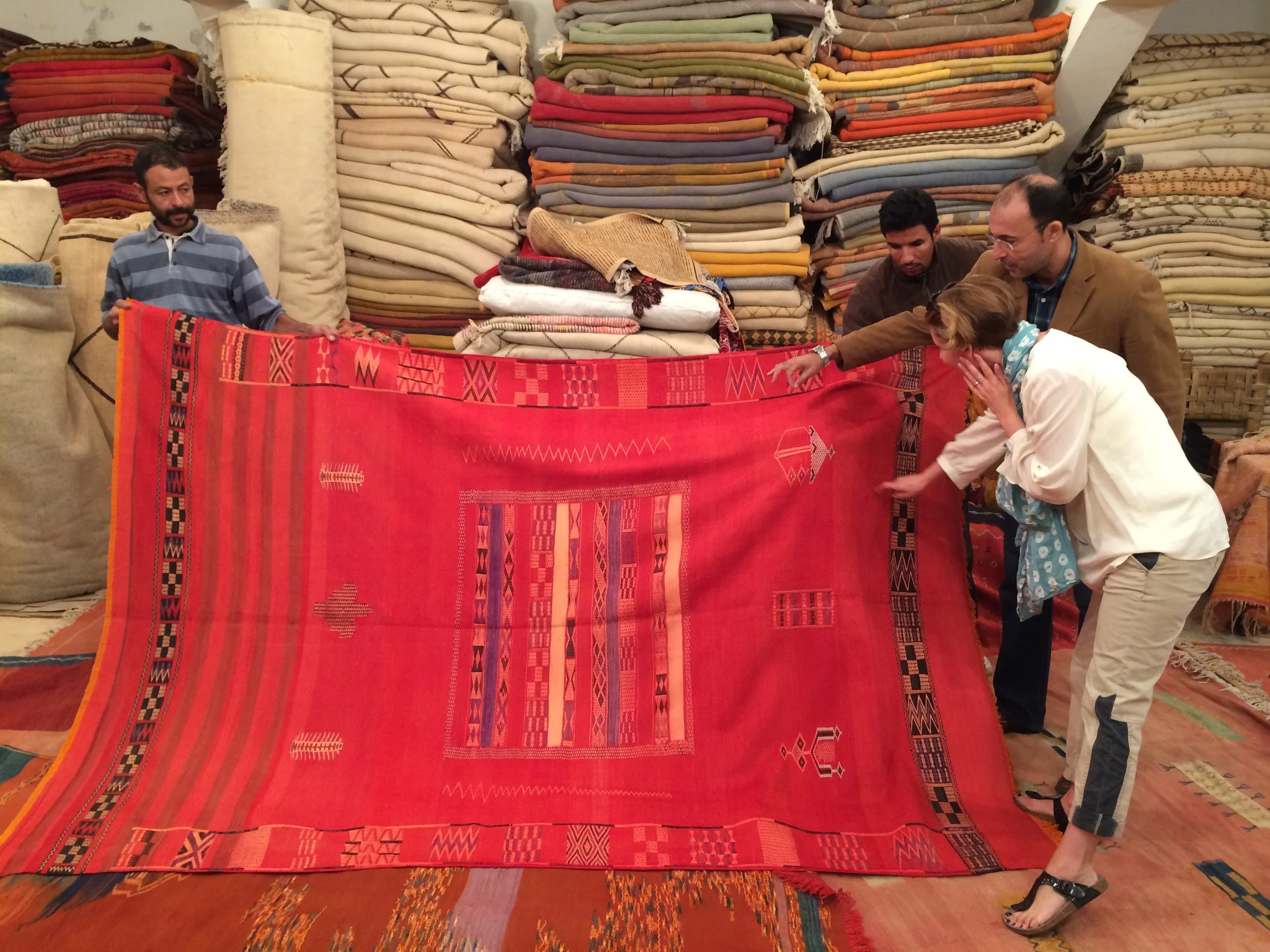 Hakim explains an antique silk carpet