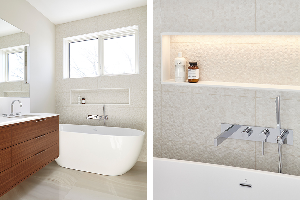 Modern bathroom with freestanding bathtub, wooden vanity, and built-in shelf holding toiletries.