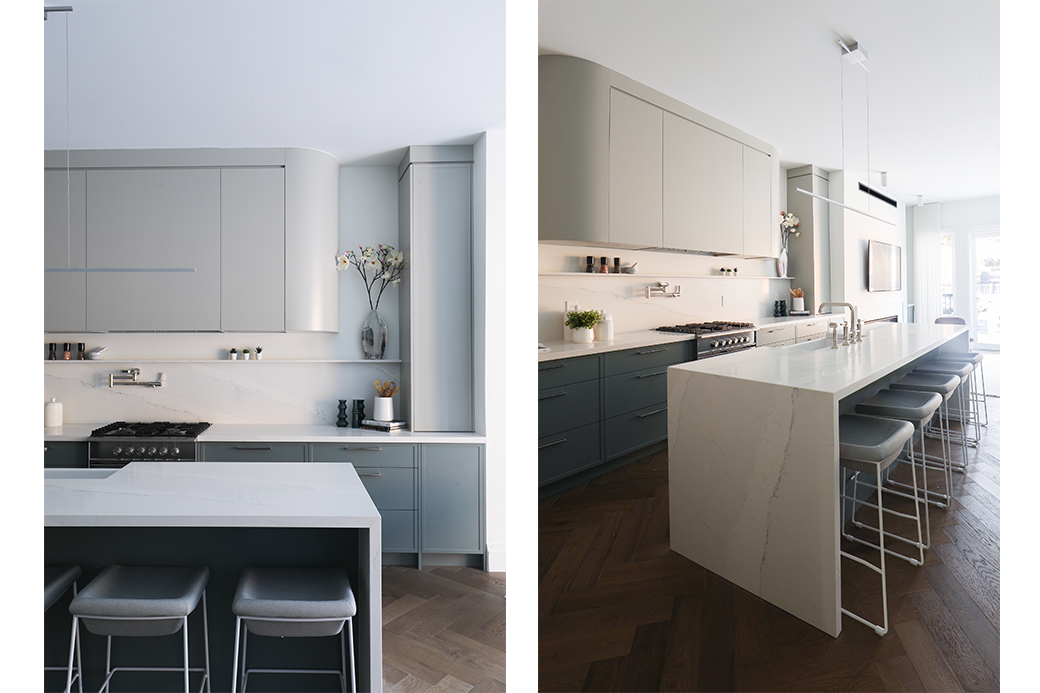Modern kitchen with marble countertops, gray cabinets, and a kitchen island with bar stools.
