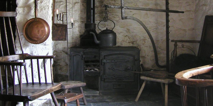 Original kitchen containing an impressive inglenook fireplace with Welsh Country antiques set against the lime-washed walls.