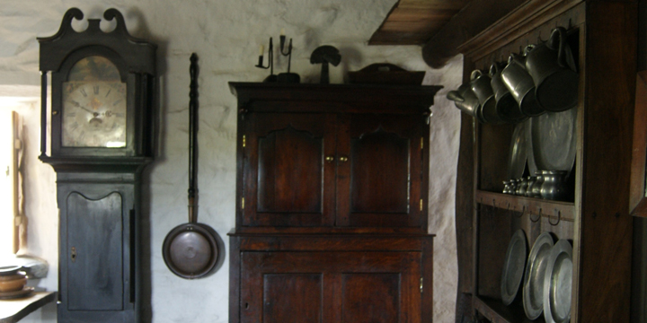 Small kitchen beneath mezzanine with basic appliances.
