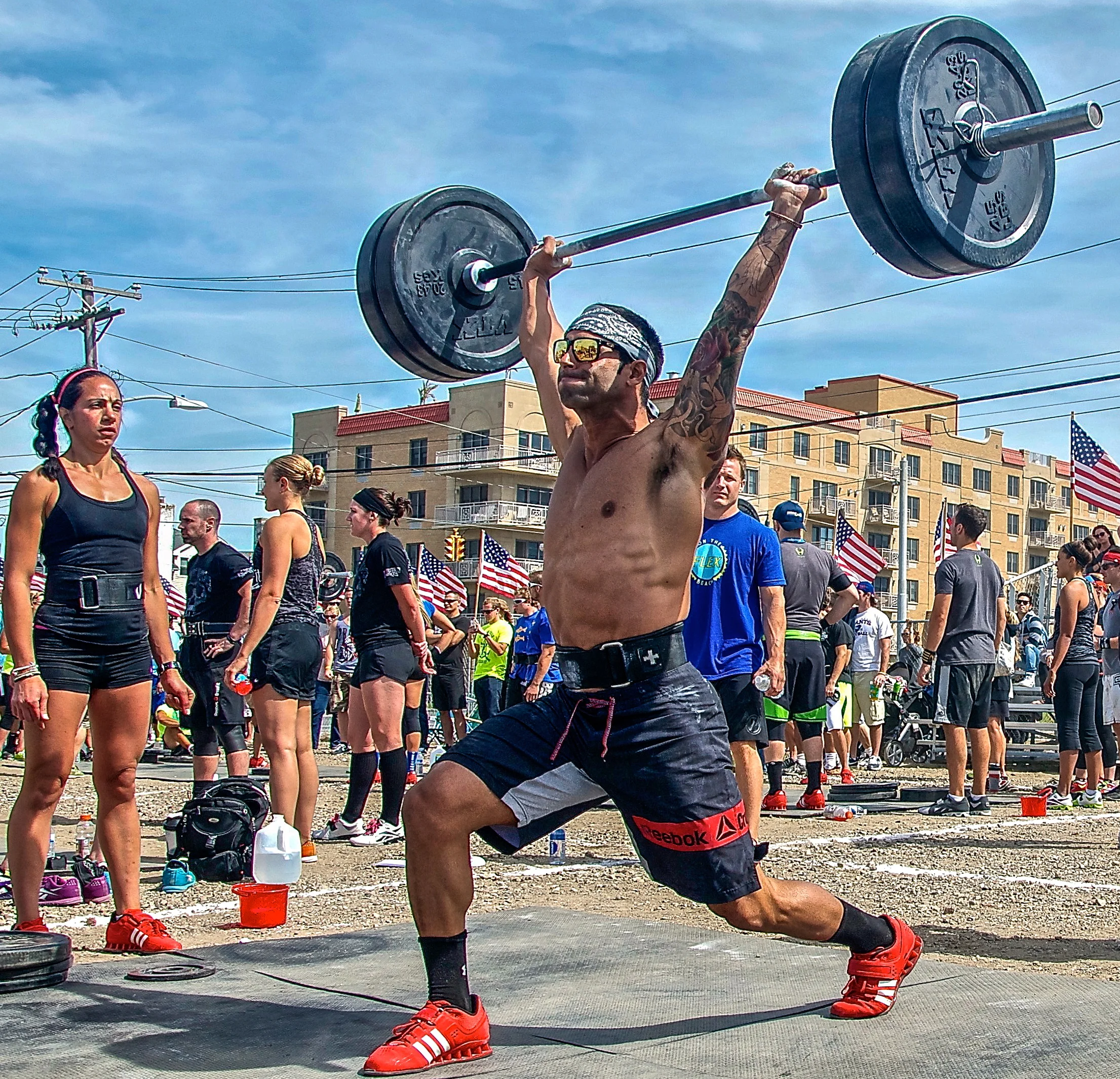  A weightlifter cleans a barbell overhead during a crossfit competition in Long Beach, New York. 