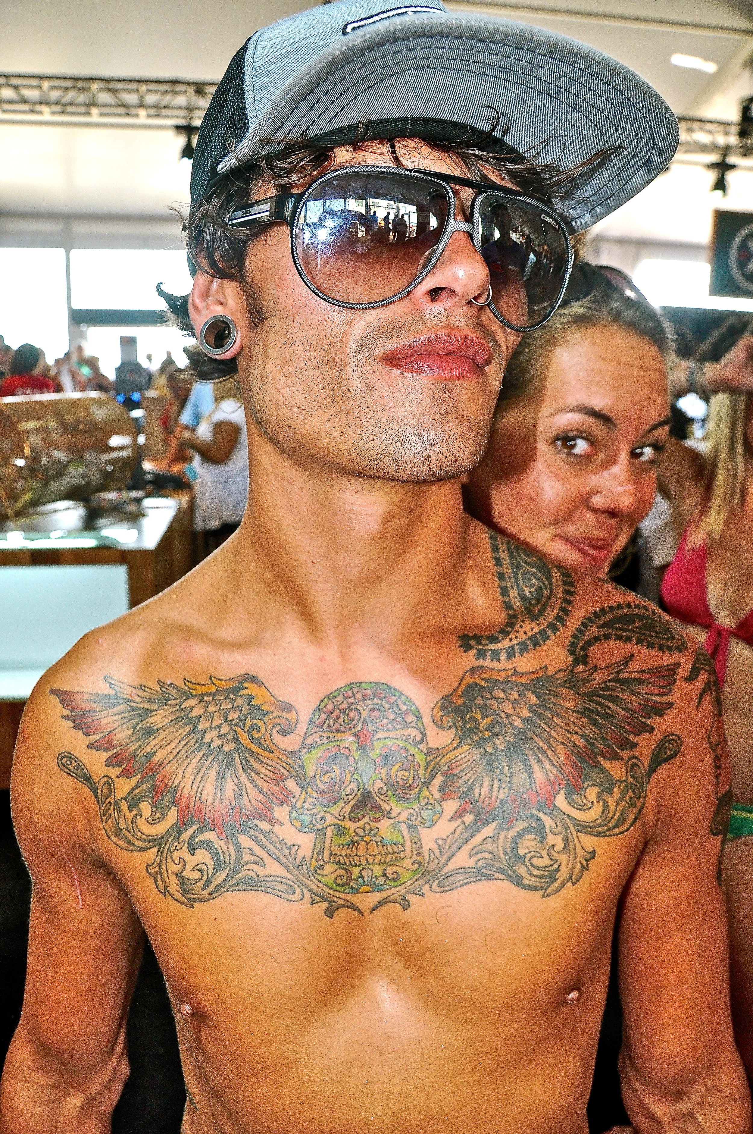  A tattooed customer at the surf shop at the Quicksilver Pro New York in Long Beach, New York.&nbsp; 