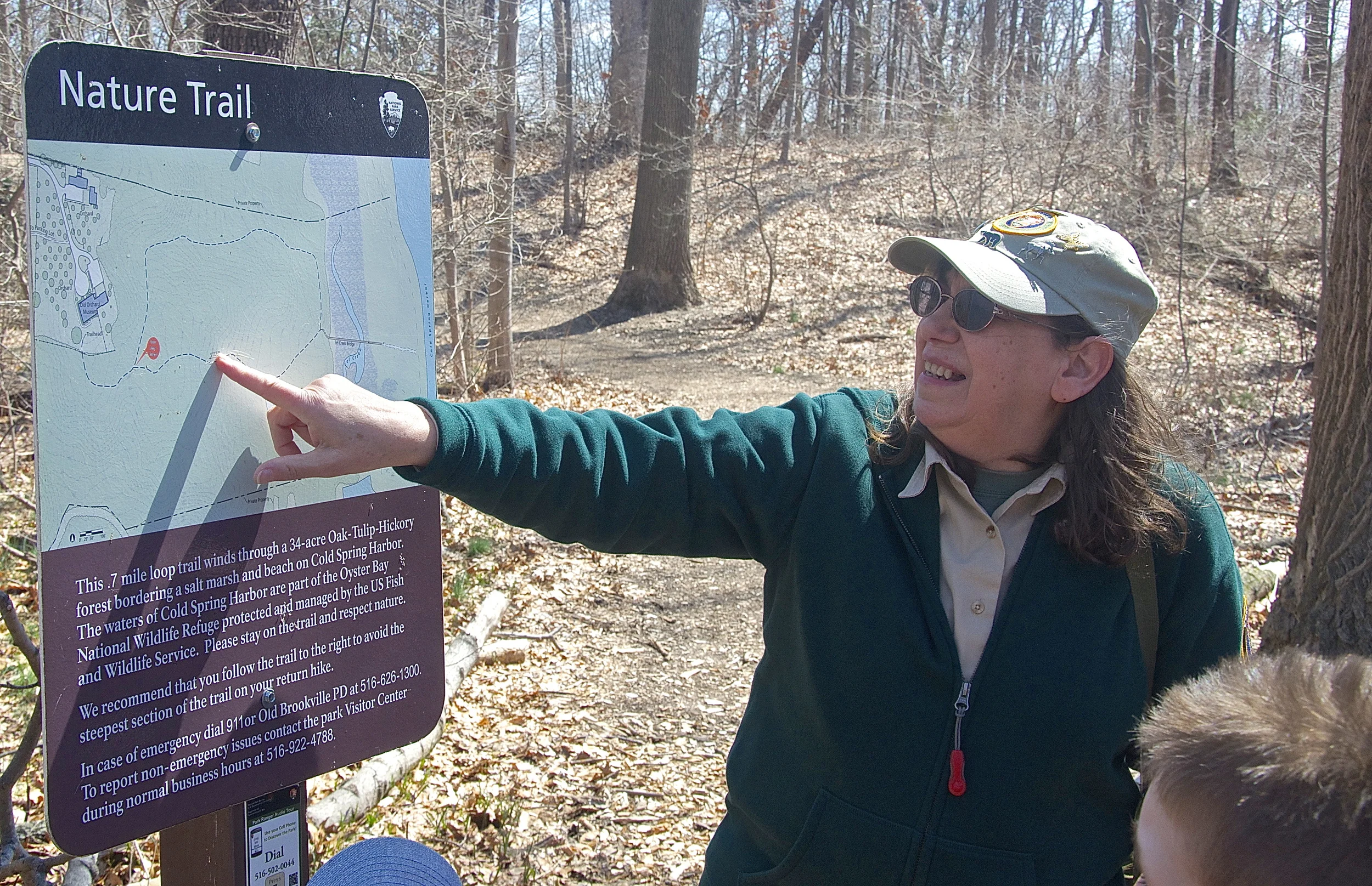 Naturalist Lois Lindberg pointed out the different trails for people that she led on a hike in the woods of Sagamore Hill Historic Park. (Photo: Joseph Kellard) 