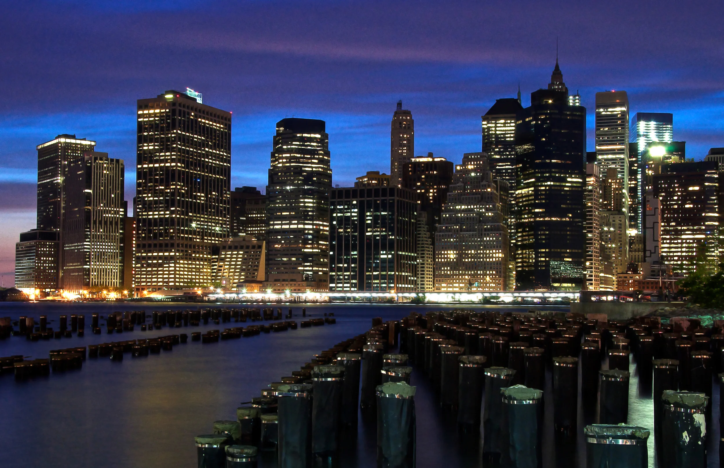 A view of the Lower Manhattan skyline as seen from Brooklyn Bridge Park and across from pilings in the East River. (Photo: © Joseph Kellard/kellardmedia.com)