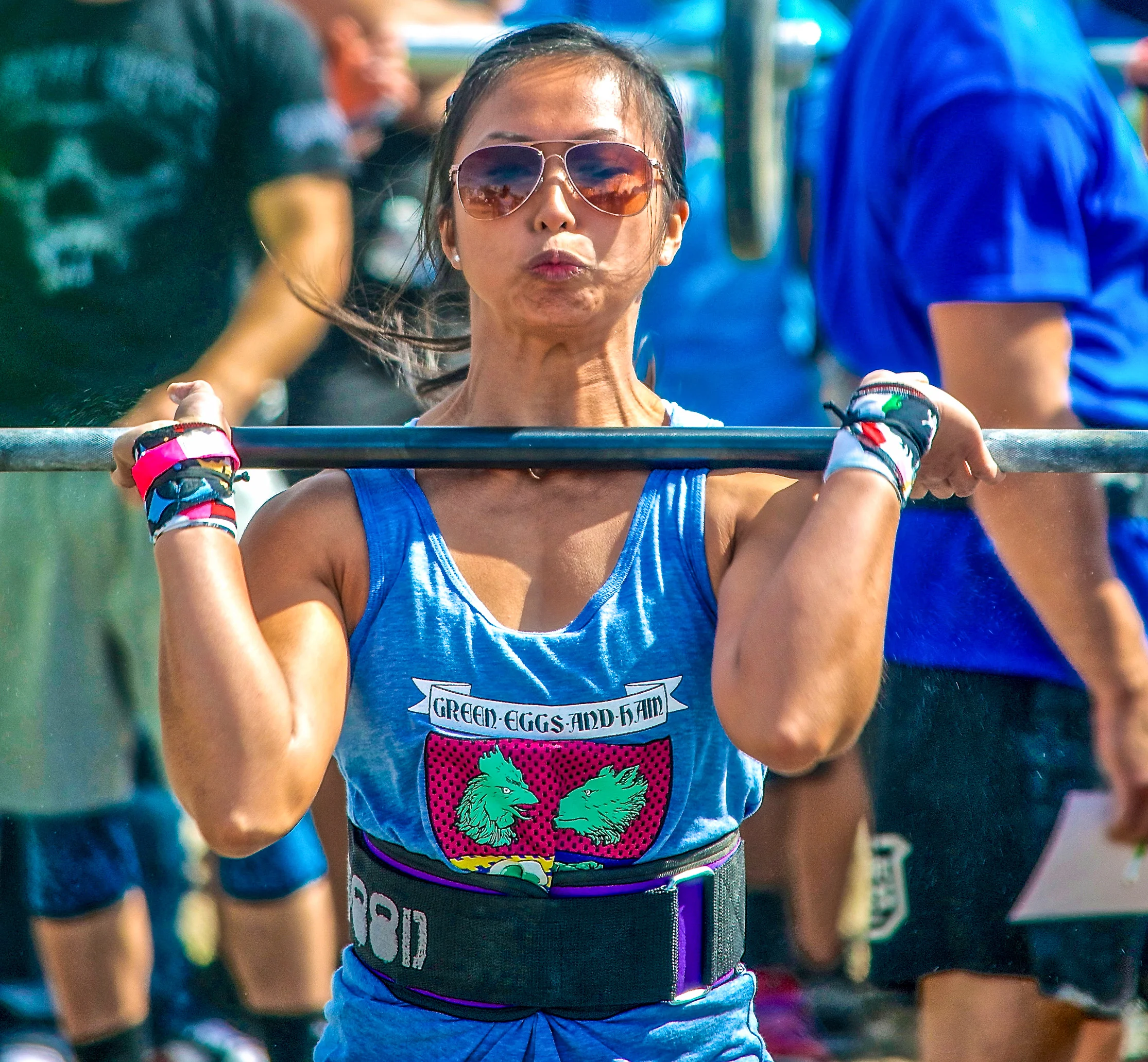  A powerlifter in shades prepares to press barbell during a crossfit competition in Long Beach, New York. 
