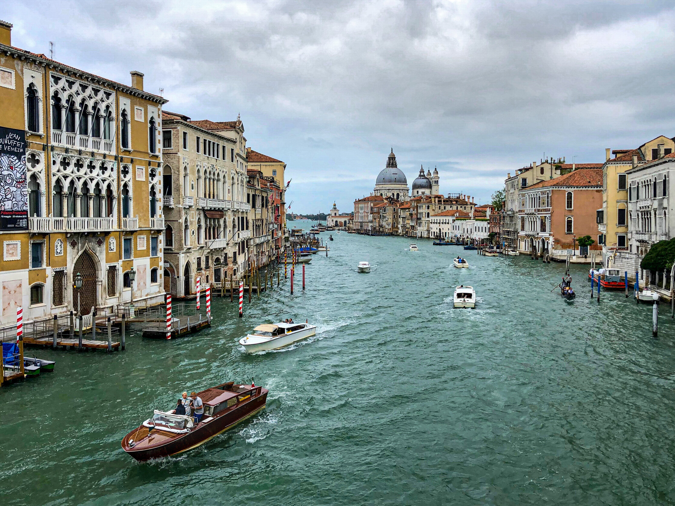  I snapped this photo while crossing Ponte dell'Accademia, one of four bridges that span the Grand Canal, the major waterway that runs through Venice. This is a view of the southern end of the canal, with the dome of the Basilica di Santa Maria della