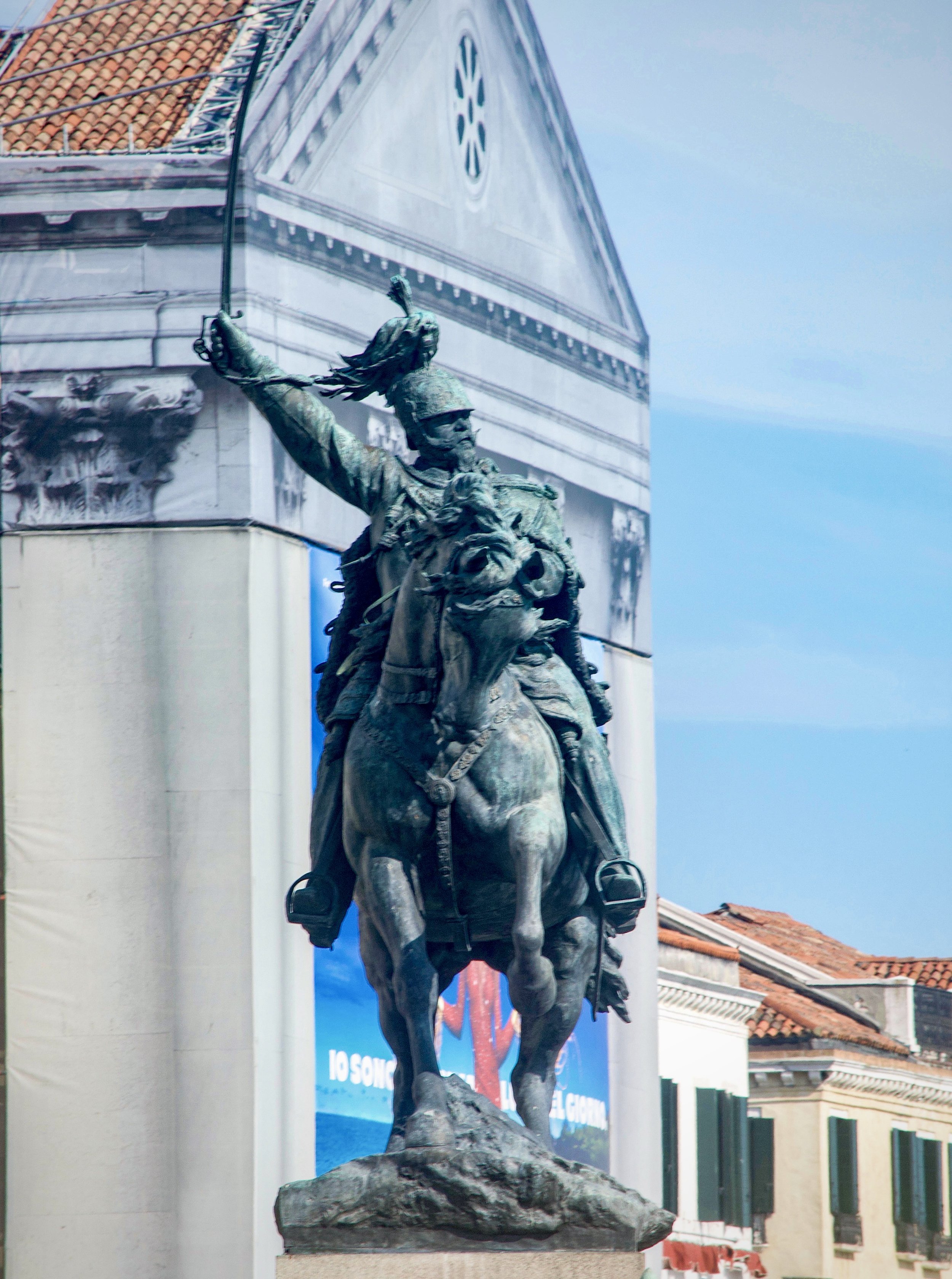  An equestrian statue of a sword-wielding Victor  Emmanuel II, the first king of a united Italy, at the Riva degli  Schiavoni promenade on the Saint Mark's Basin in Venice.  Italian sculptor Ettore Ferrari (1845-1929) created the bronze  monument tha