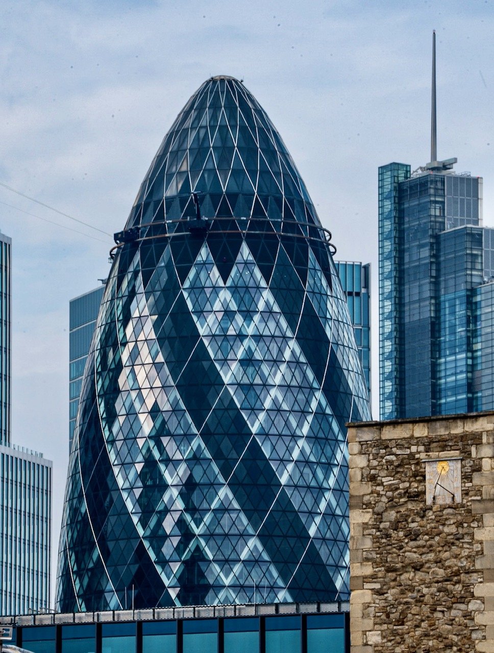 The Gherkin, designed by British architect Norman Foster, was completed in 2003. This elongated oval-shaped skyscraper is constructed of steel, glass, and concrete, and rises 41 stories into the London sky. Formerly known as the Swiss Re Building, t